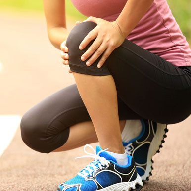 Female Runner With Injured Knee