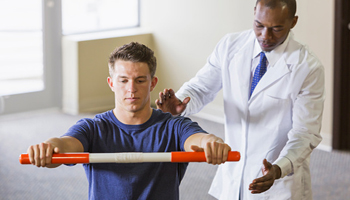 orthopaedist guiding rehab exercise